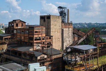 Historic industrial area in Ostrava, Czech Republic. Damaged industrial building with a mining tower in the background