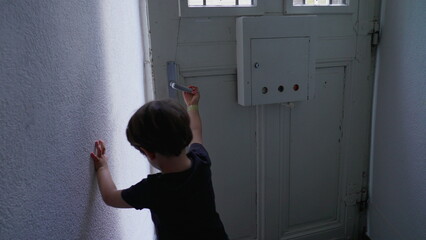 Child opening apartment front door and stepping out. Little boy open home entrance, going out to...