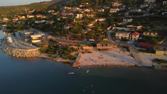 Aerial drone view of a Shiroka lake beach at sunset near Shkoder. Albania