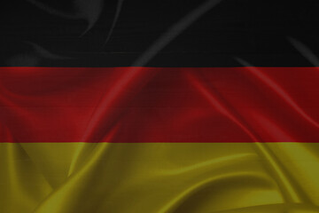Fototapeta premium German flag over a grunge wooden background. Tag der Deutschen Einheit.