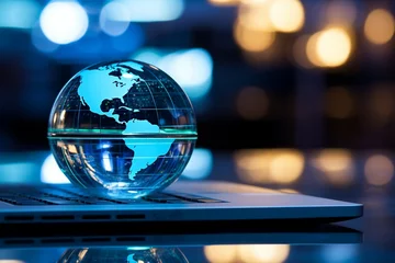 Foto op Canvas A glass globe on a laptop symbolizes a global business perspective © Muhammad Shoaib