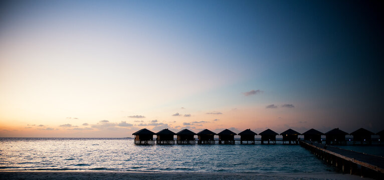 water bungalows at sunset