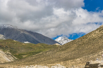 Dark Clouds HImalayan Mountains and Road to Korala Border between Tibet China and Upper Mustang,...