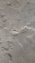 Whitewash. Old peeling whitewash. Peeled plaster wall