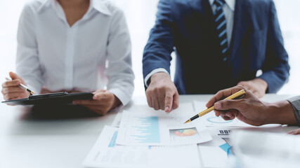 Business people, teamwork and meeting for strategy, planning or corporate brainstorming discussion at office. Business people meeting explaining the financial graph data and marketing plan.