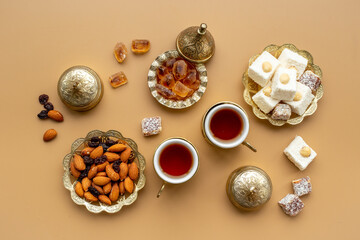 Muslim holiday with tea in traditional bronze cups with sweets