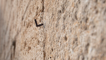 Rusty nail in an old stone wall