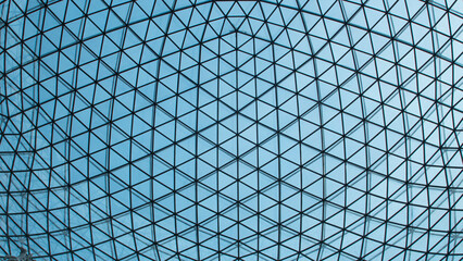 Texture ceiling triangles of a glass dome behind the blue sky - Powered by Adobe