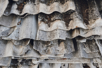 Old and very dangerous asbestos roof. Asbestos dust in the environment. Health problems.