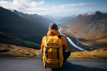 A traveler explores picturesque mountain landscapes with a yellow backpack