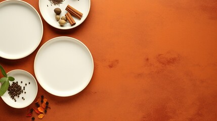 Obraz na płótnie Canvas Three set of empty white plates on the orange concrete table with few spices, herbs and chilies above top view, in the style of minimalist backgrounds.
