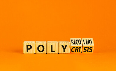 Polycrisis or polyrecovery symbol. Concept words Polycrisis Polyrecovery on wooden cubes. Beautiful orange background. Businessman hand. Business Polycrisis or polyrecovery concept. Copy space.