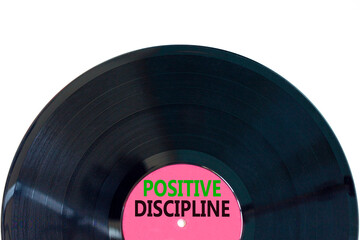 Positive discipline symbol. Concept words Positive discipline on beautiful black vinyl disk. Beautiful white table white background. Business psychology positive discipline concept. Copy space.