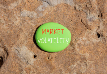 Market volatility symbol. Concept words Market volatility on beautiful big green stone. Beautiful...