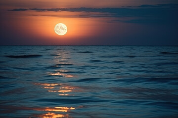 A large full red moon over ocean horizon with reflection on the water 