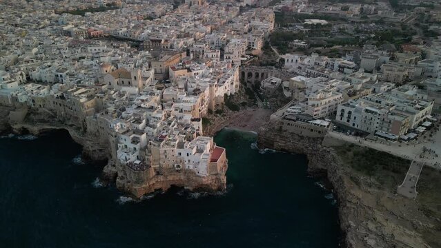 Aerial view of Polignano a mare at sunset in the province of Bari in Puglia. A country on the sea a wonderful landscape