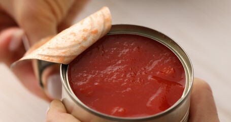 Opening a can of chopped Italian tomatoes. Cooking bolognese sauce. Food preparation in the kitchen. A series of photos to visualize the recipe.