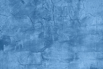 Texture of old blue painted wall, chipped, scratches. Stucco wall. Natural vintage background