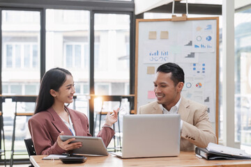 Young business people meeting and planning teamwork in the office happily