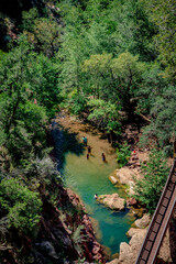 People swim in a pond in Pine Creek at Tonto Natural Bridge State Park in Payson Arizona - 644557967
