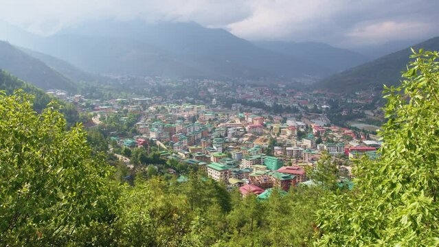 Panoramic view of the city of Thimphu located in Bhutan, with clouds over mountains in Thimphu city