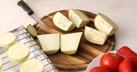 Cut eggplant on a cutting board. Cooking in the kitchen. Food preparation. Close-up.