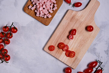 Step by step frittat. Vegetable omelet. Salad preparation ingredients. Slicing cherry. Flat lay.Horizontal photo, space for text