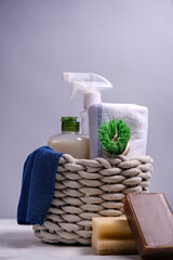 Brushes, sponges, rubber gloves and natural cleaning products in the basket. Eco-friendly cleaning products