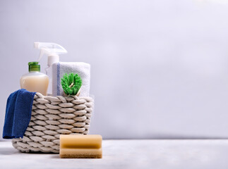 Brushes, sponges, rubber gloves and natural cleaning products in the basket. Eco-friendly cleaning products