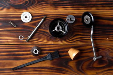 Top view of disassembled manual coffee grinder on an wooden background