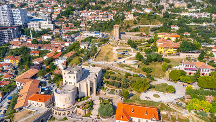 Aerial drone view of Kruje Castle and its fortress, inside the Kruje tower and museum with the mountains in the background. Albania. Cenital plane