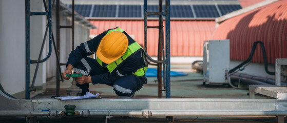 A team of engineers is checking the air conditioning cooling system of a major building or industrial facility.