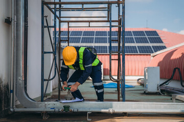 A team of engineers is checking the air conditioning cooling system of a major building or...