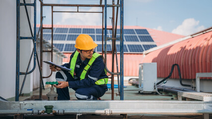 A team of engineers is checking the air conditioning cooling system of a major building or industrial facility.