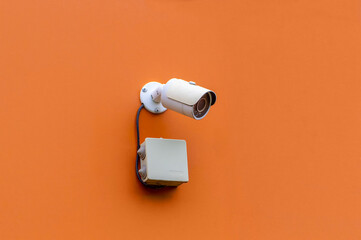 security camera on orange wall. High quality photo