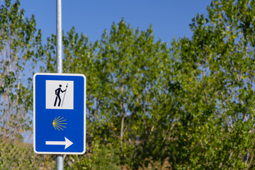 Road sign totem with yellow shell, that guides pilgrims along the Camino de Santiago