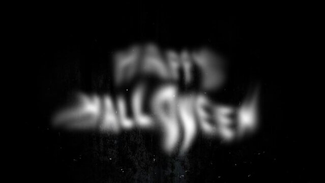 Blurred letters Happy Halloween from the bottom of the screen. Horror ghostly letters on against a dark and ominous creepy wall, accompanied by swirling particles of dust, perfect for Halloween theme