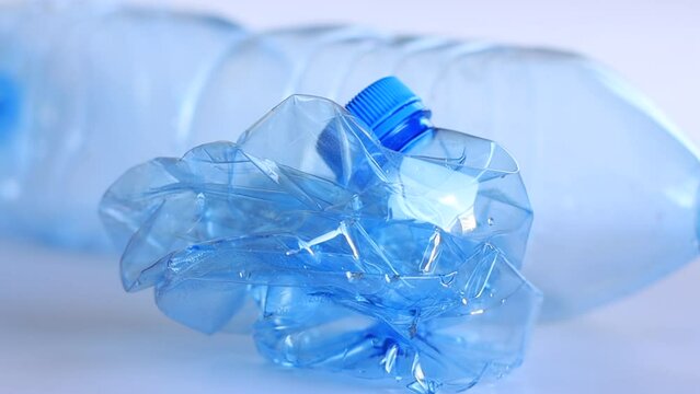 Recyclable plastic bottle: before and after crushing, plastic recycling.