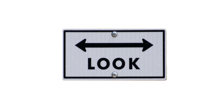 An isolated look both ways street sign with a two sided arrow against a blank background - isolated on white