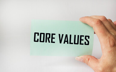 Text Core Values on a colored sticker in a mans hand, copy space