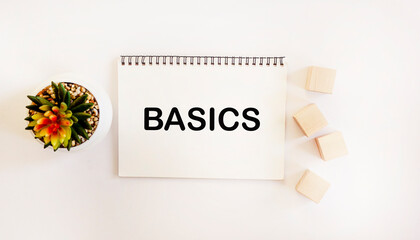 The word BASICS written on a notepad and white background