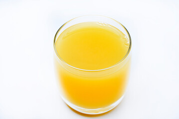 Glass glasses with orange juice on a white background. Delicious orange cooling drink.