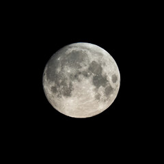Detailed image of the full moon isolated on black.