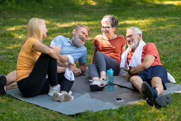 Happy Cheerful Senior Men And Women Relaxing Outdoors After Sport Training