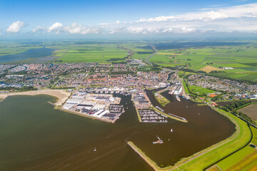 Aerial image of the city of Lemmer, Friesland, The Netherlands. With the harbour, marina and old village. Green meadows and Frisian lakes in the background