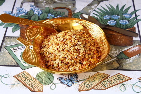 Split Roasted Coriander Seeds also known in india as Dhana Dal or Sukh Mukh mukhvas isolated in golden dish  