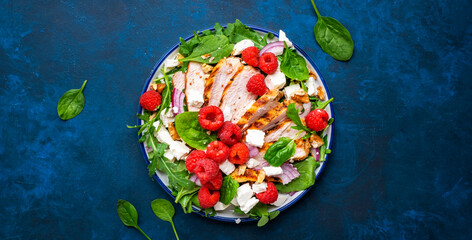 Gourmet salad with raspberries, grilled chicken, feta cheese, red onion, walnuts, spinach and mixed...