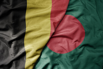 big waving national colorful flag of belgium and national flag of bangladesh .
