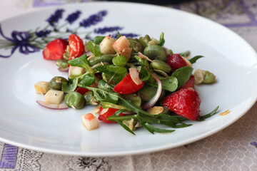 salad with strawberries and broad beans. Delicious dish in a healthy style