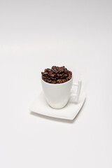 white cup filled with coffee beans,white cup with coffee,white cup with coffee beans on a white background
